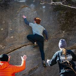 student climbing a boulder at rumbling bald