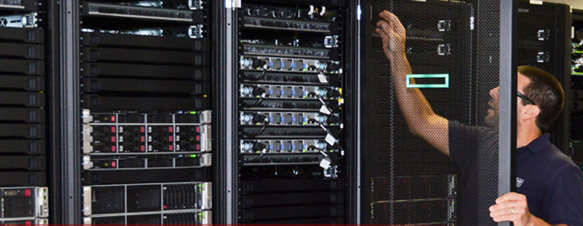 A man reaches behind a door for a research computer.