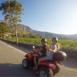 a guy and girl on a moped