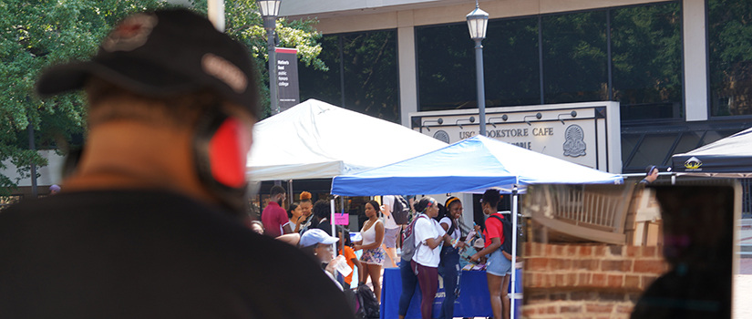 DJ spins looks on as he plays songs on Greene St. 