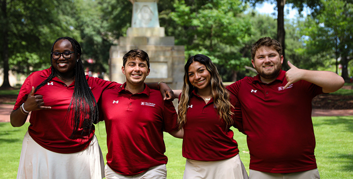 Orientation Leaders smiling outside and posing for a picture outside on the Horseshoe