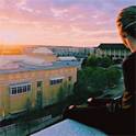 Girl on top of parking garage watching the sunset