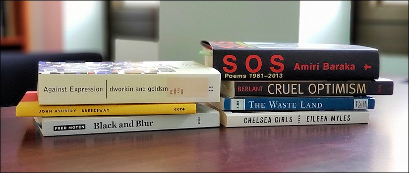 Books laying on their side on a top of a desk