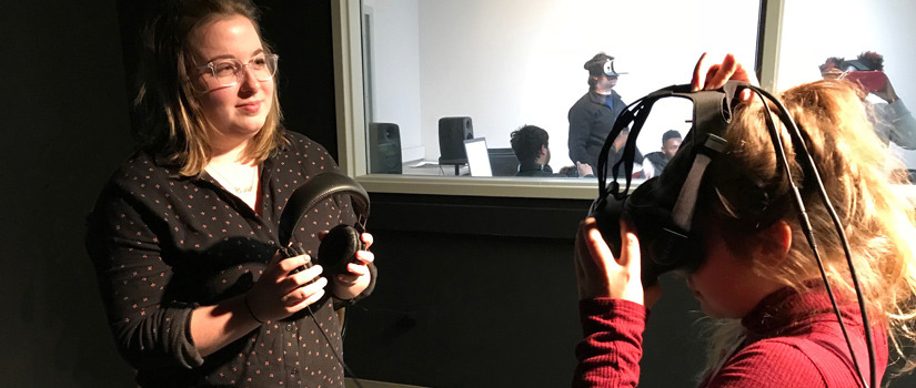 students in a lab setting trying on virual reality equipment