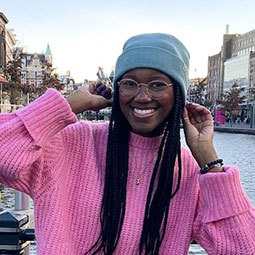 girl with pink sweather on smiling