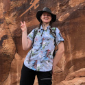 Amber Wellings posing in front of an illustrated rock