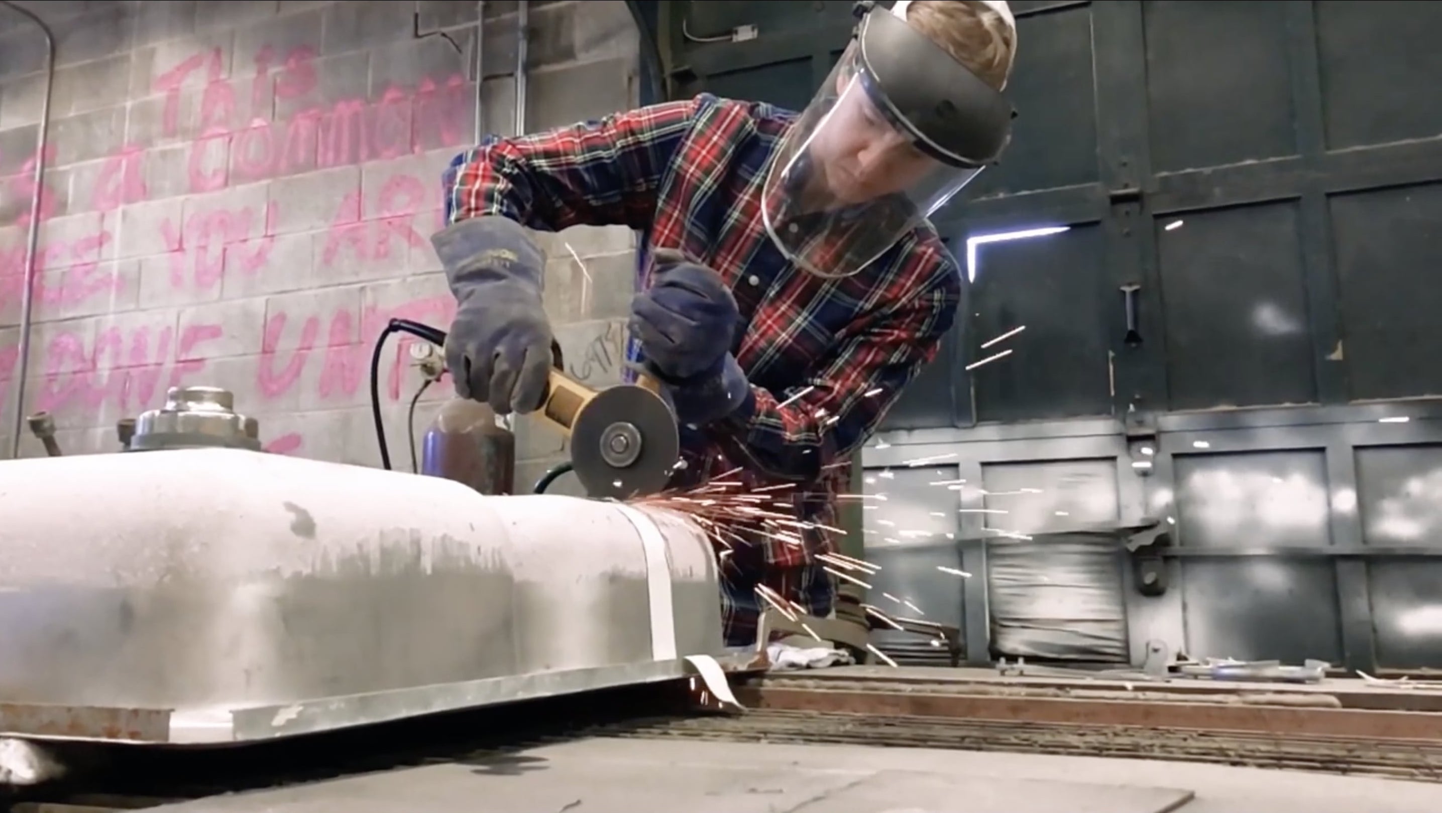 student working with angle grinder