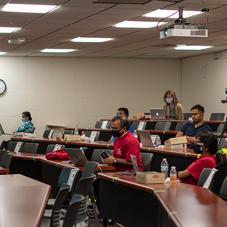 people sit in socially distanced classroom