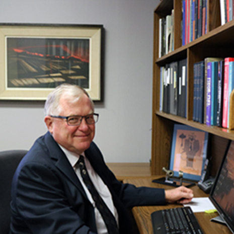 Dr. Dryer sits at a desk