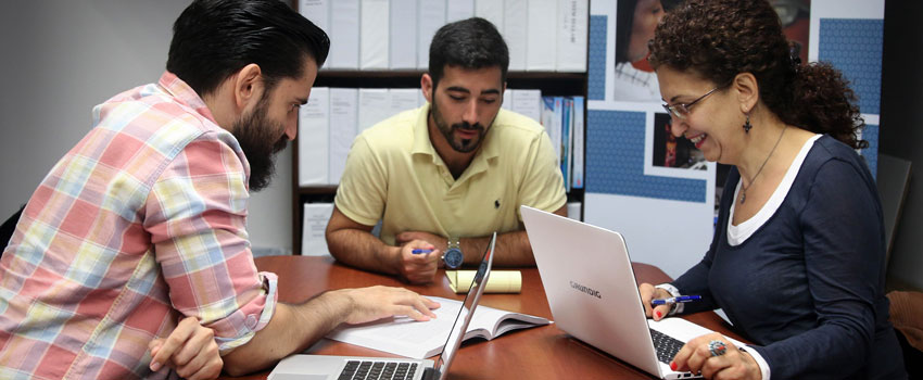 Three students work together on a project.