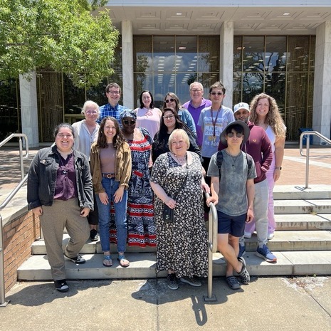 Participants of the 2024 Dissertation Writing Academy standing on the steps in front of the library.