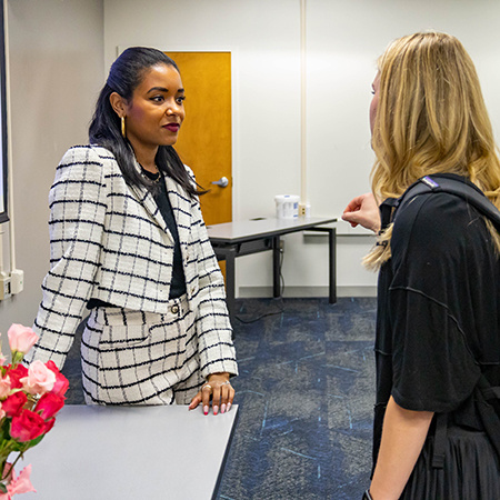 HRSM alumna Megan Pinckney Rutherford speaks with a student after giving a presentation.