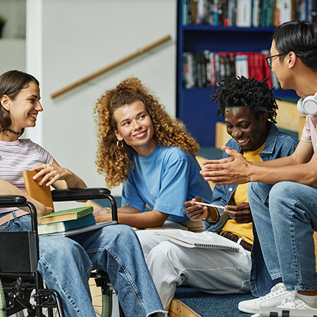 Young people chatting in college library