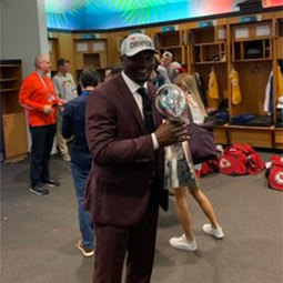 Coach Rod Wilson holding Super Bowl trophy