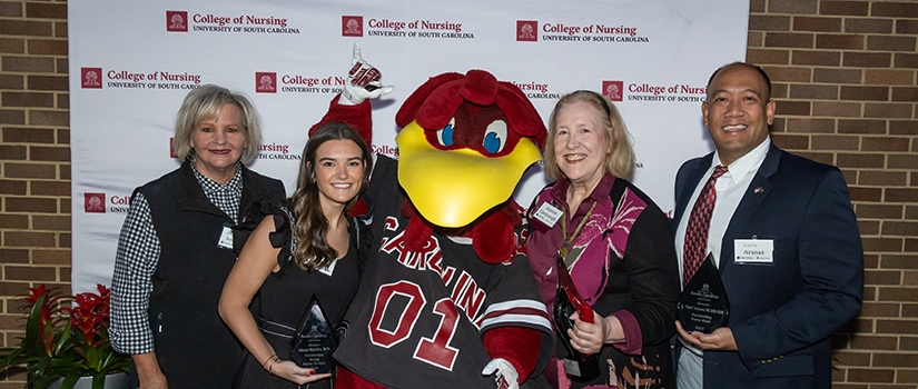 Dean Andrews with three alumni award winners and Cocky 