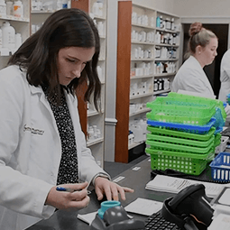 pharmacist behind a counter