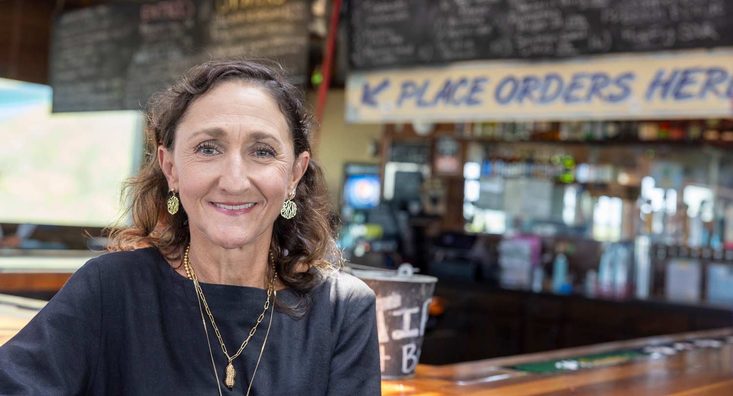 Hope Barber stands in front of the bar at her family’s restaurant Bowens Island