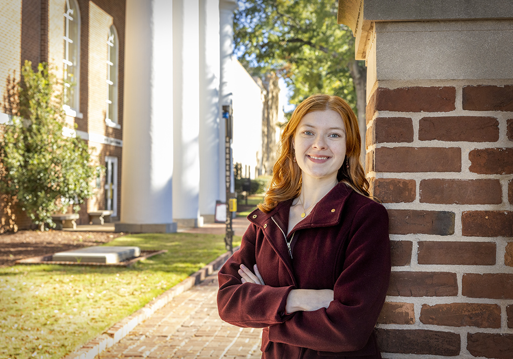 Gracie Bellah poses in front of the South Caroliniana Library.