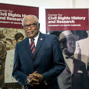 James Clyburn speaks to the media against a backdrop that says 