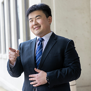 Hengtao Tang stands outside a building