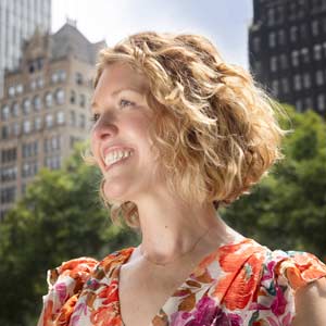 Sara Bako in Bryant Park with New York City Skyline in background