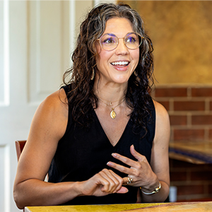 Meena Khalili sits at a table at a local coffee shop and talks about her teaching approach 