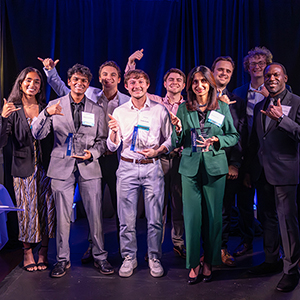 A group of winners gather together holding their awards.